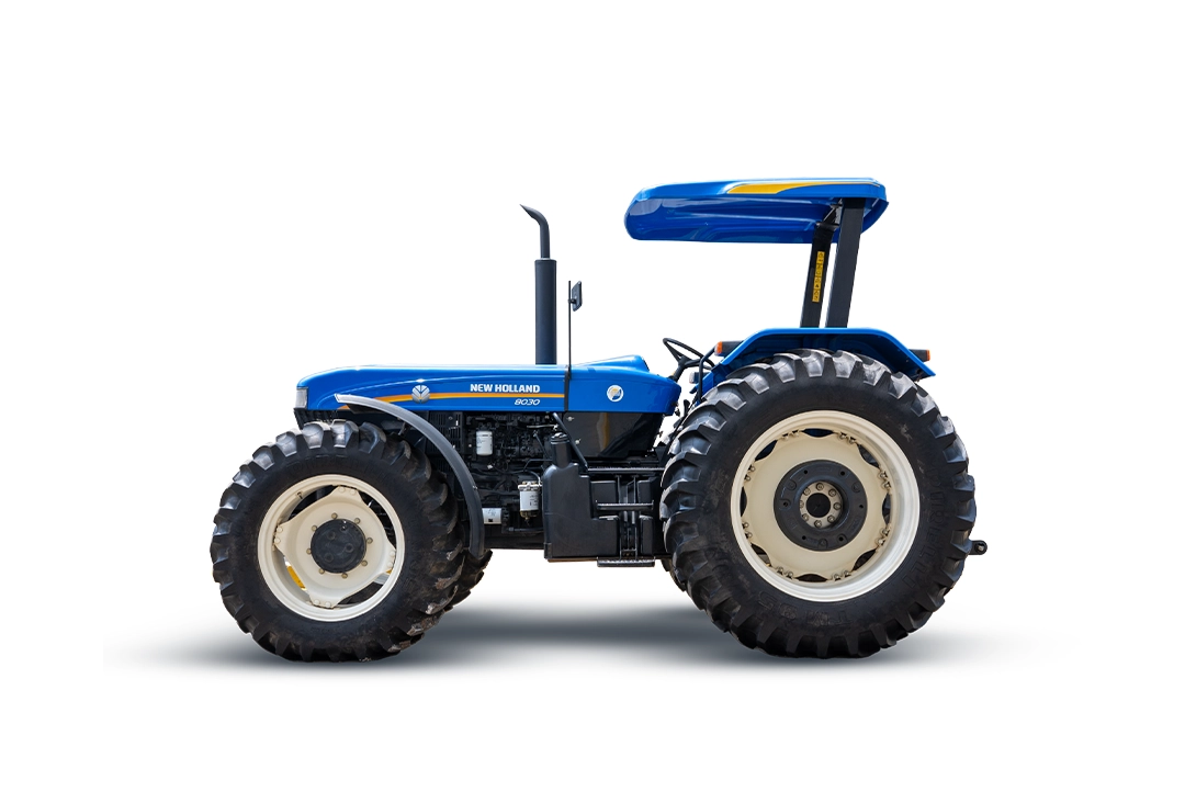 Vista de perfil de un tractor agrícola tradicional New Holland 8030 azul