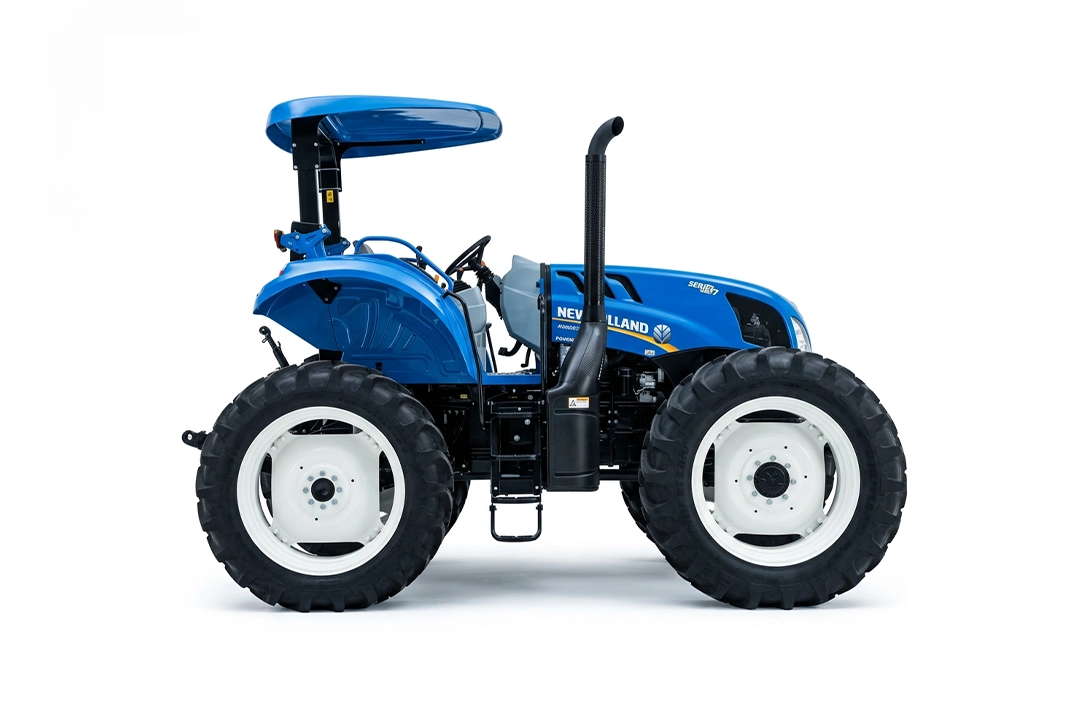 Vista lateral de tractor lodero New Holland TS6.120 con alto despeje al suelo.